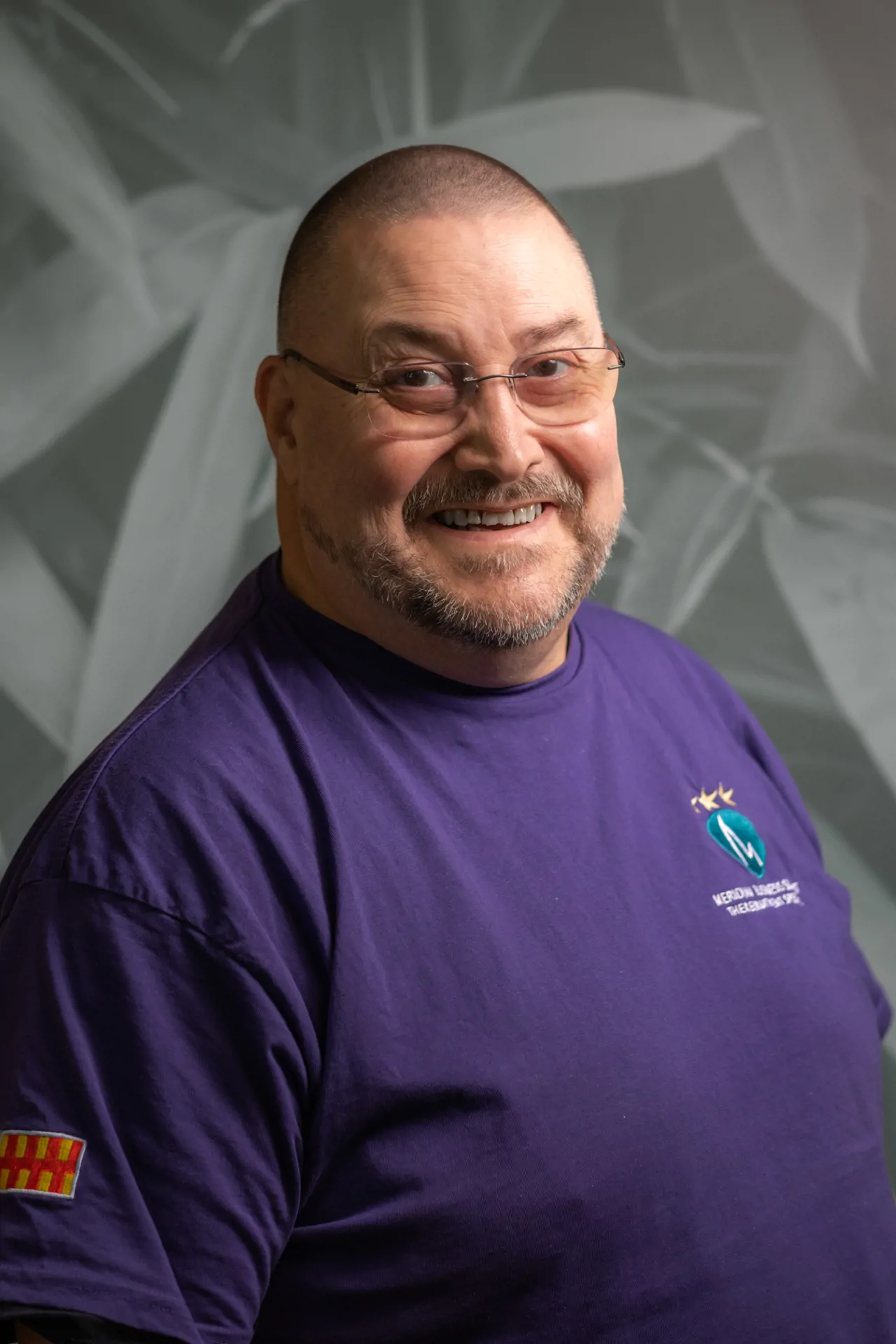 Headshot photograph of Meridian CEO Derek Skelton against a patterned background